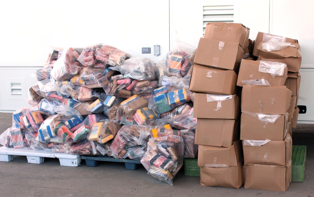 Canadian cops boast historic drug bust in front of wall of cocaine