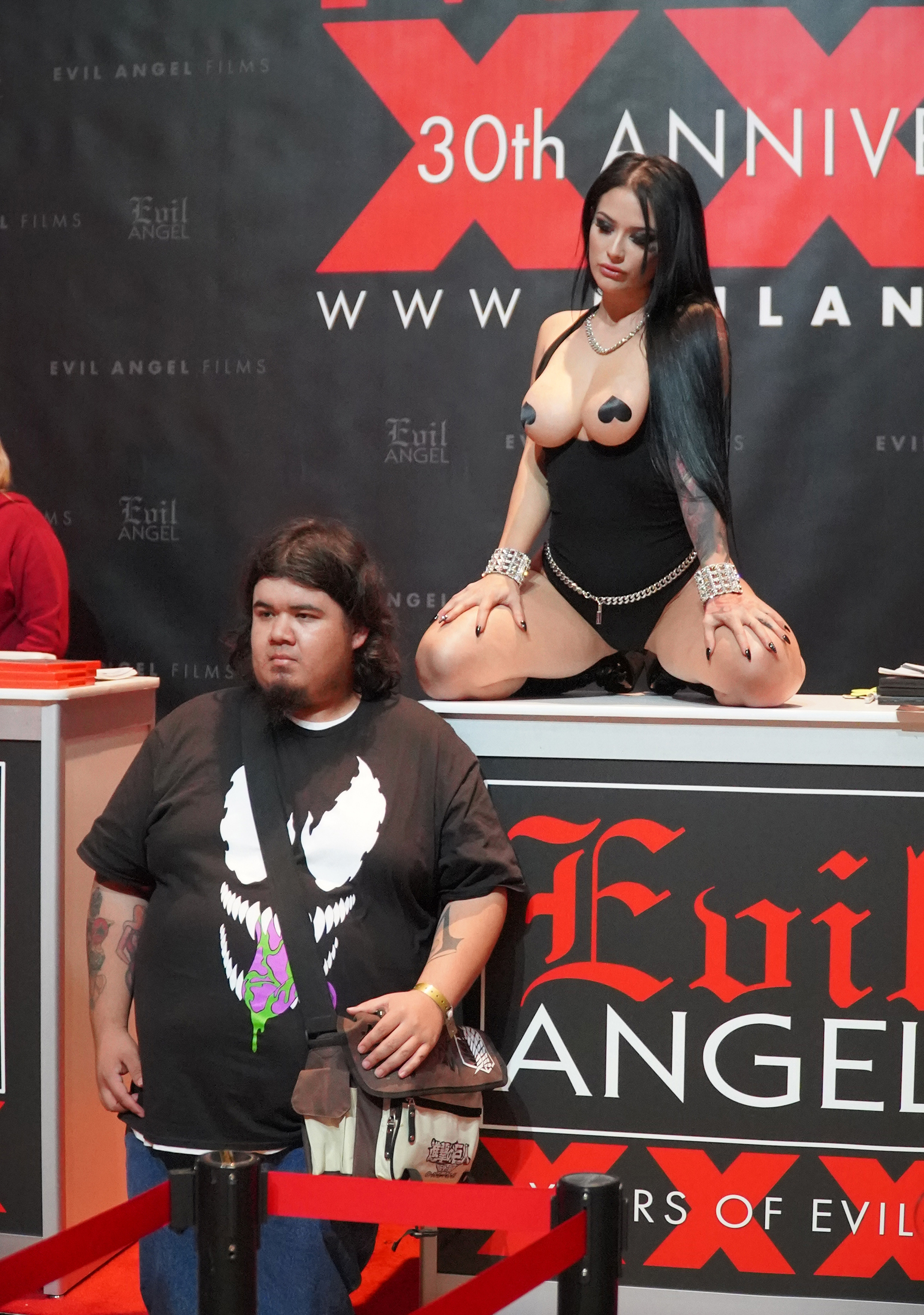 A fan posing for a photo with a porn performer