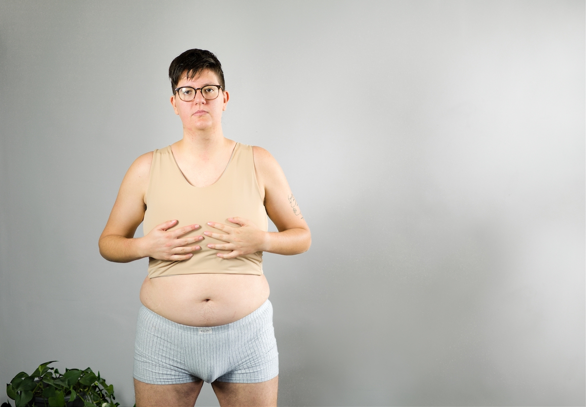 Tilke Wouters wearing a mid-length nude binder and underwear.