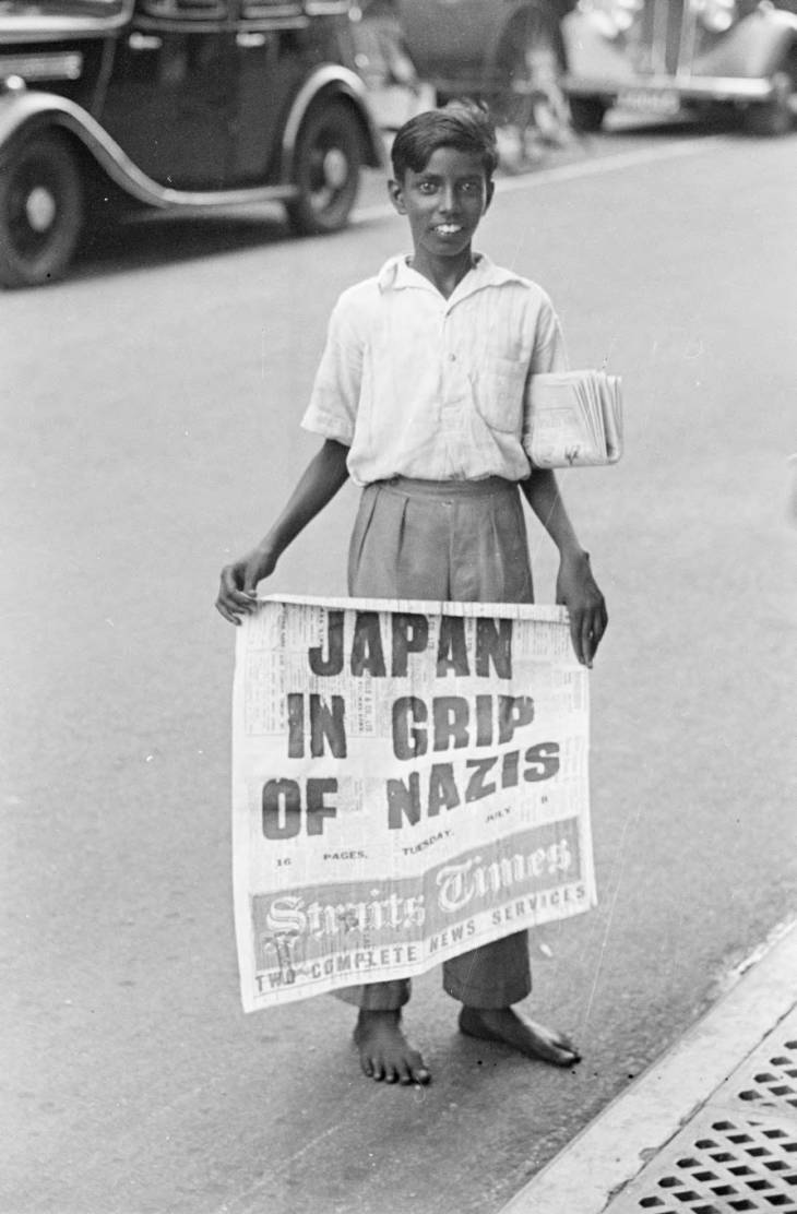 boy holding straits times newspaper in 1940s singapore