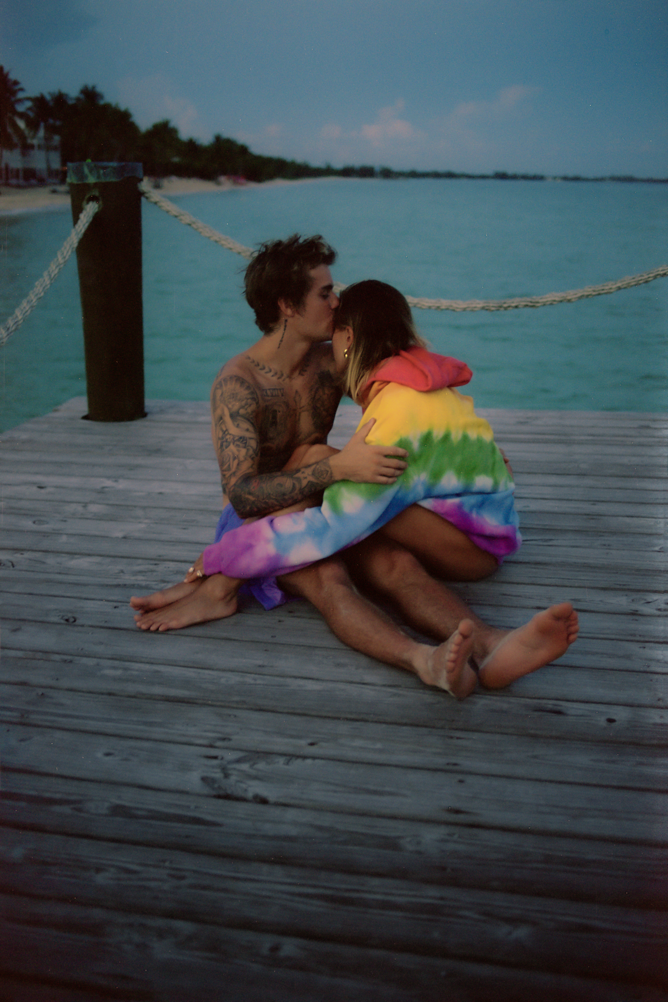 Justin Bieber kissing Hailey Bieber on the end of a dock.