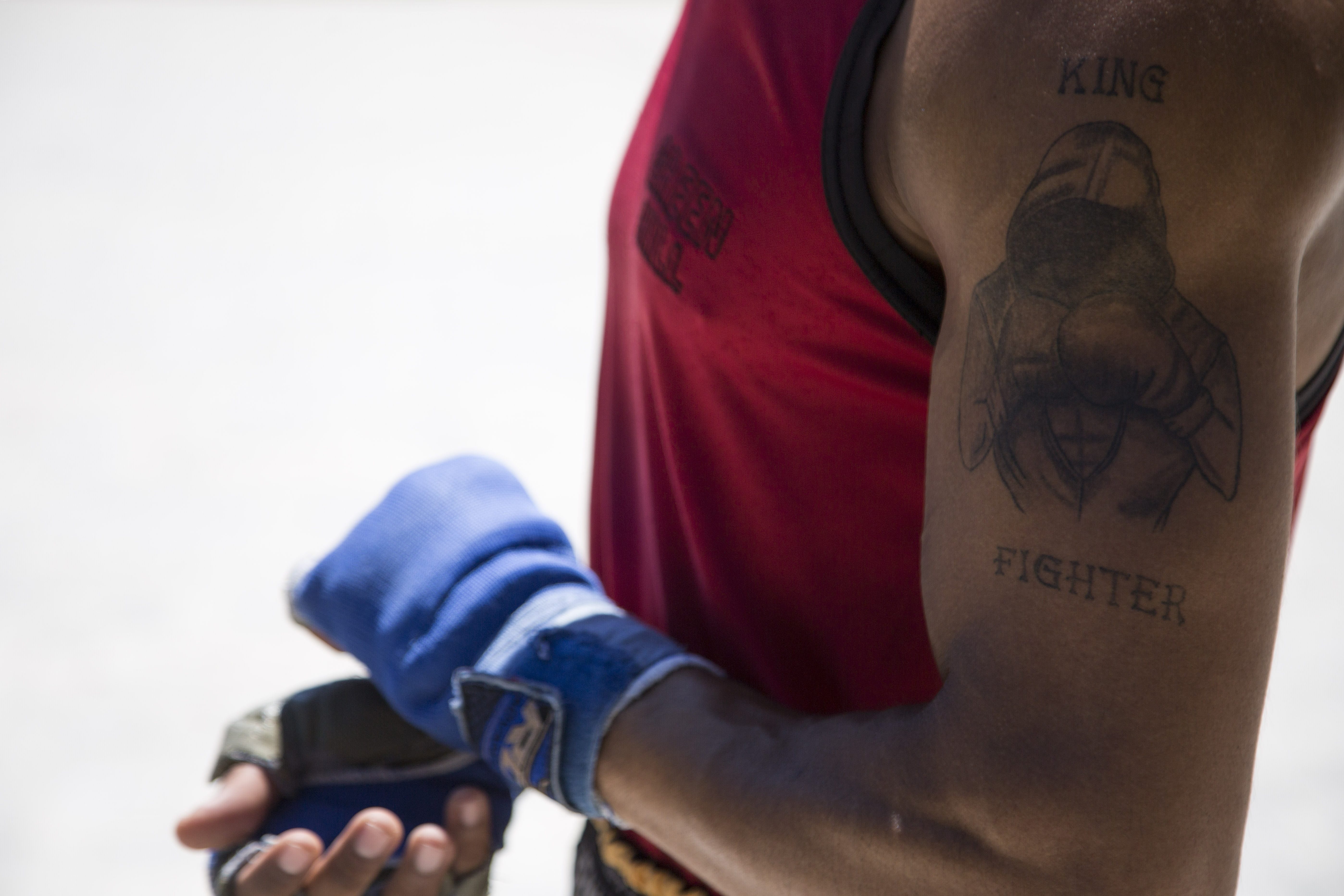 Hamid Norouzi – close up of Norouzi's arm tattoo of a boxer with the writing