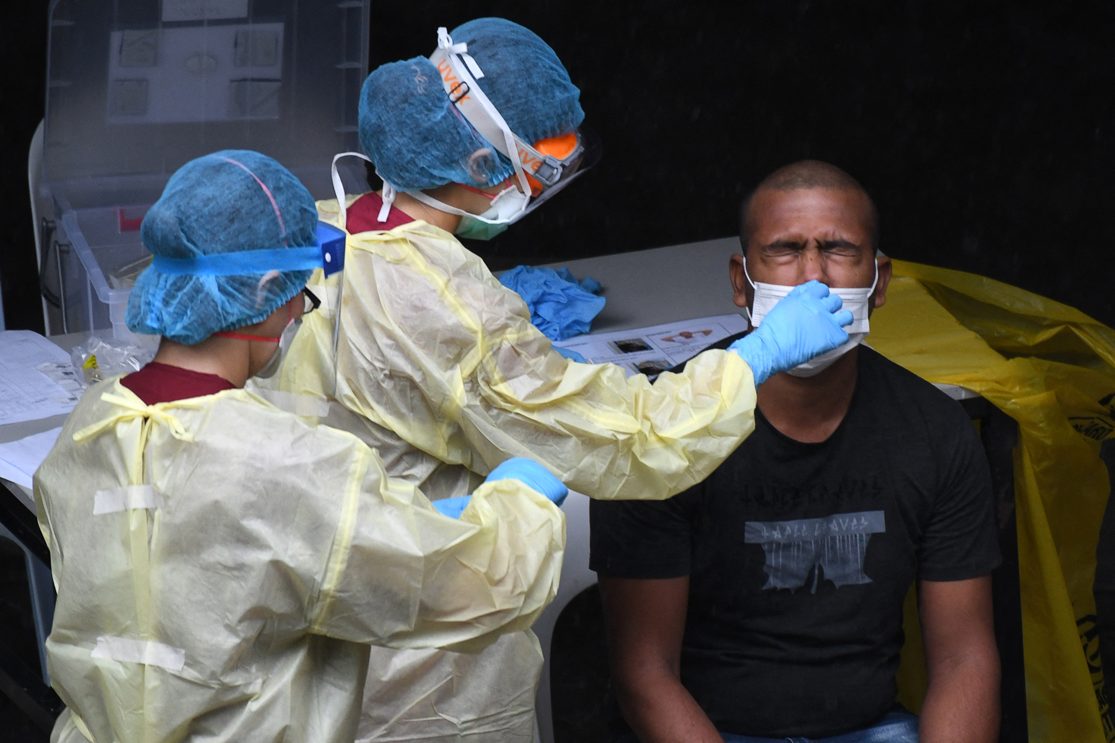 A worker is tested for the coronavirus at a dormitory in Singapore. Photo: Roslan Rahman / AFP