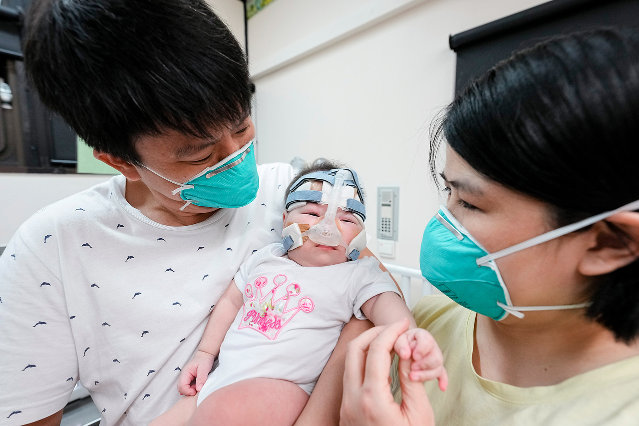 Yu Xuan seen in a recent picture with her parents. Photo courtesy of National University Hospital