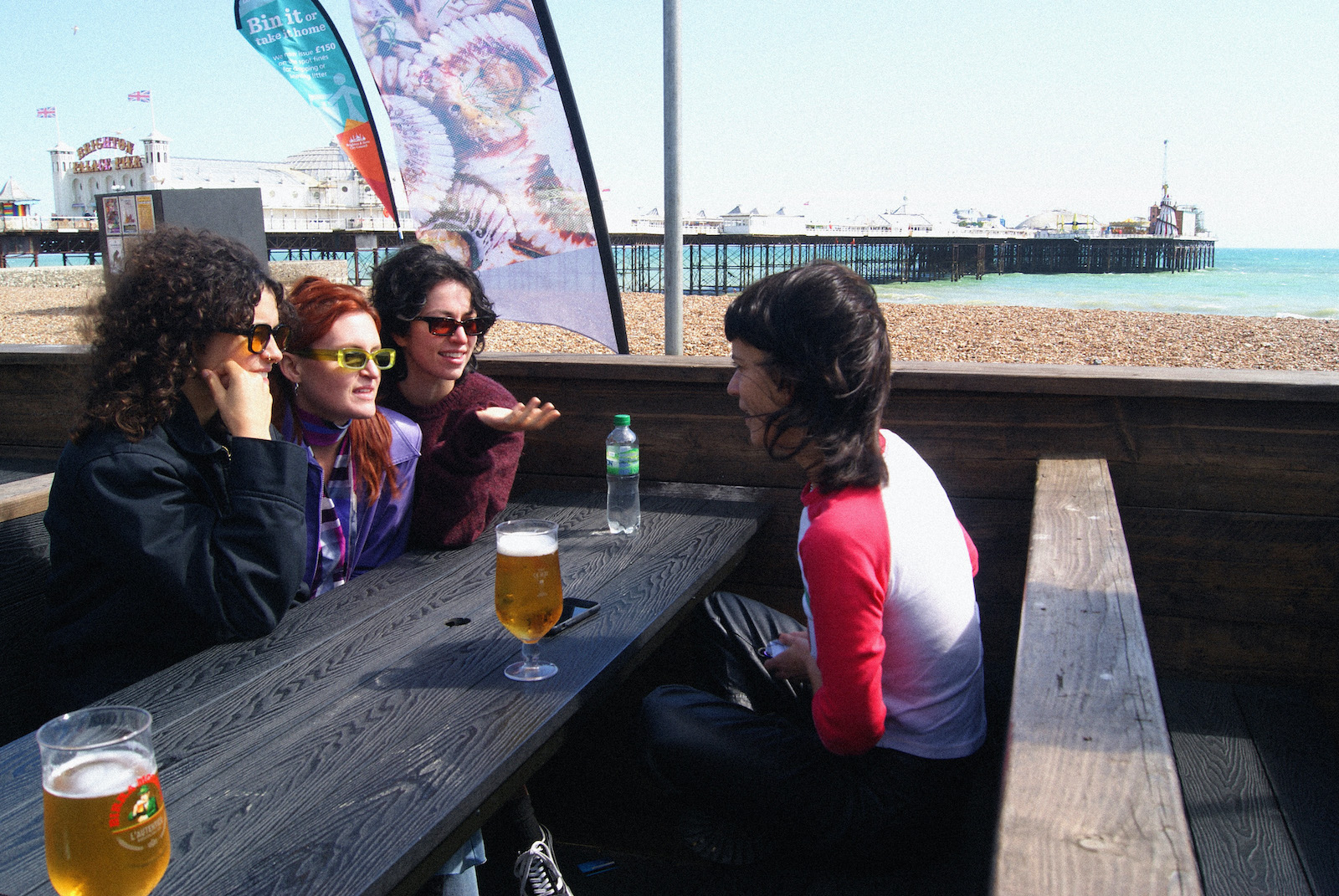 MUNA having a chat by the beach in Brighton. Photo by Amber Valence.