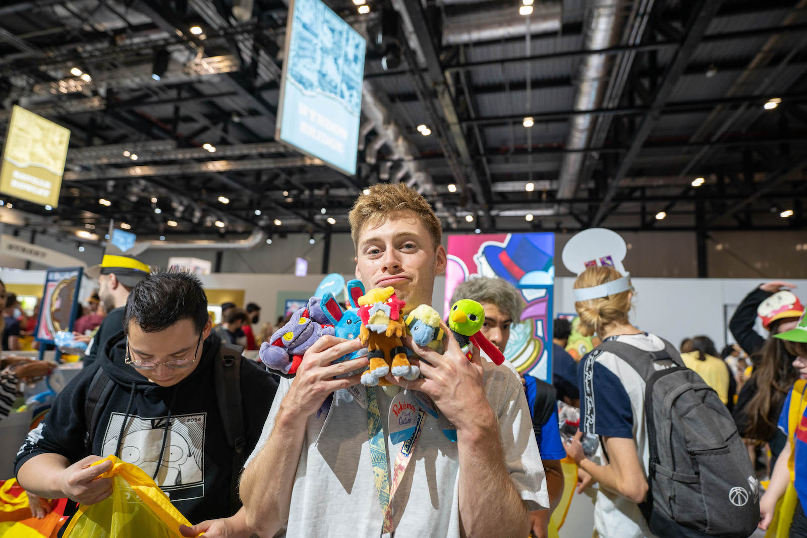 The writer, Tom Haynes, clutching multiple Pokémon plushies