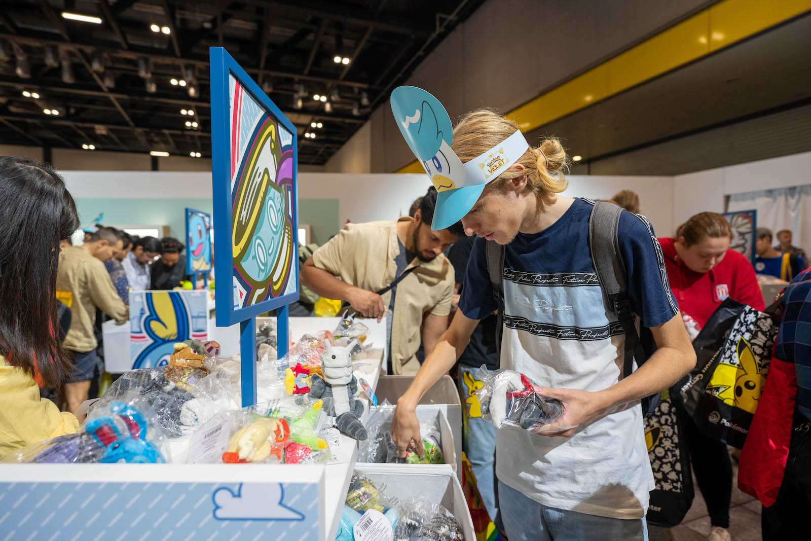 A customer buys various bits of merchandise at the Pokémon center.