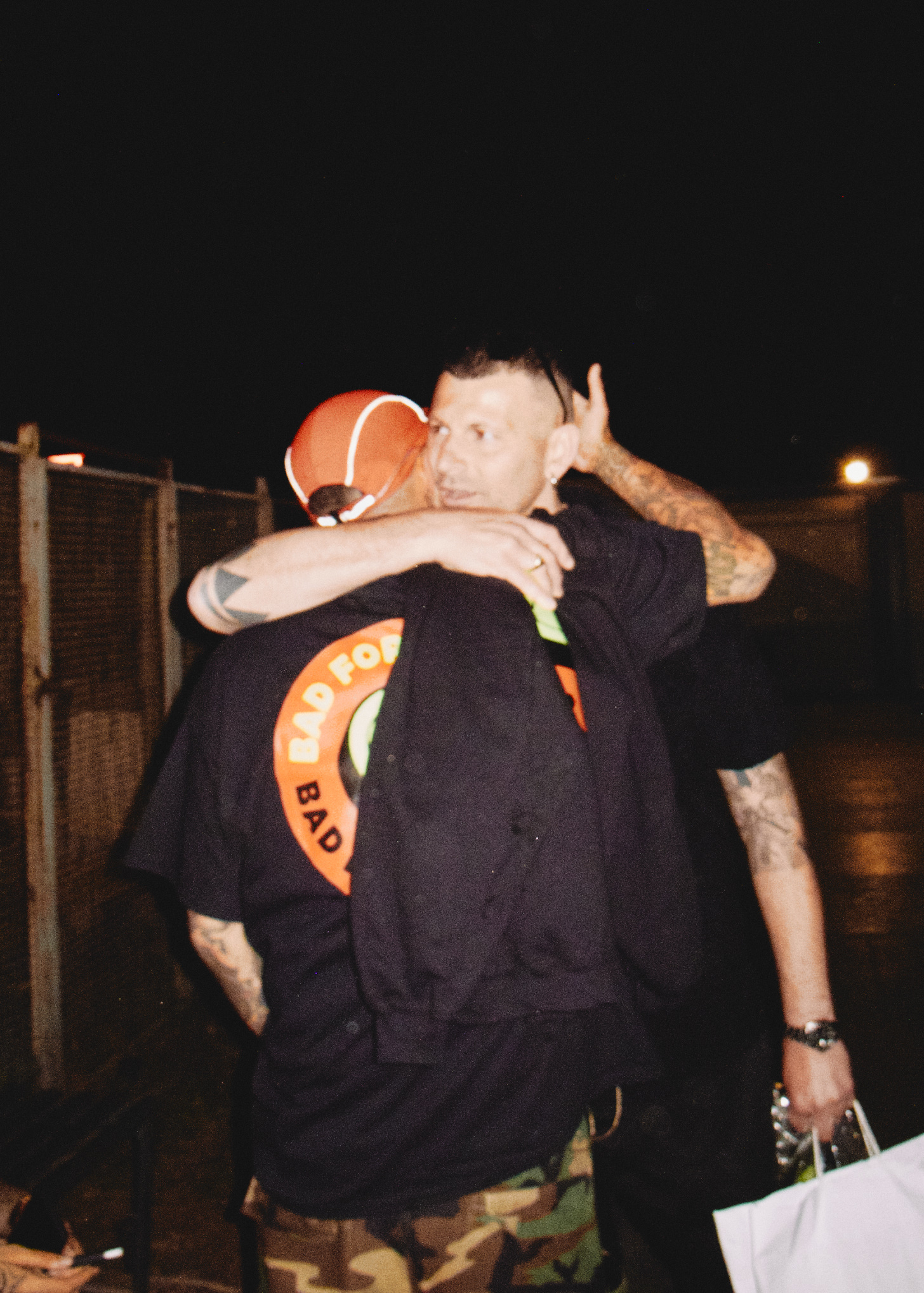 Noyz Narcos, di spalle, abbracciato da Andrew Propaganda.