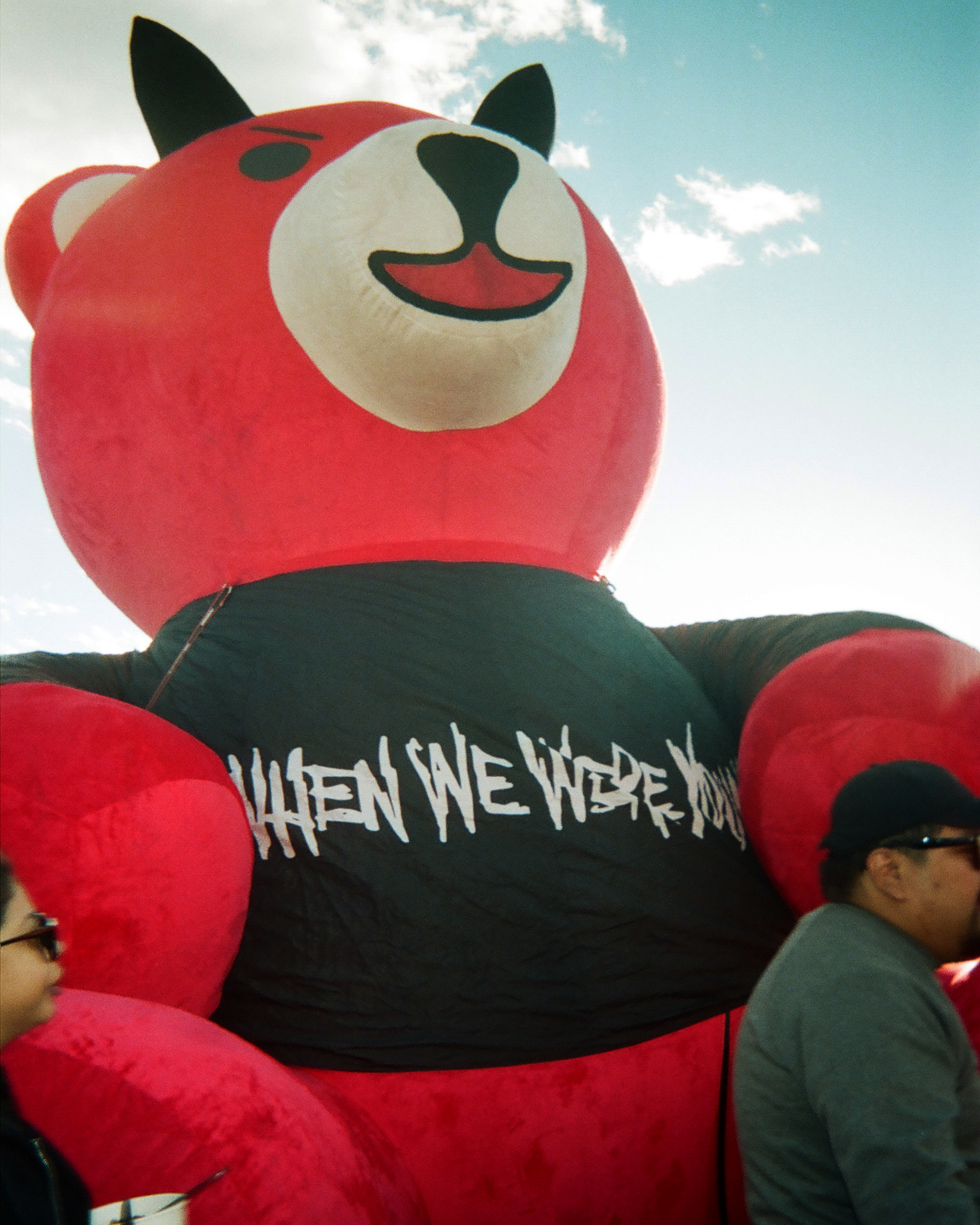 Large red bear wearing festival t shirt