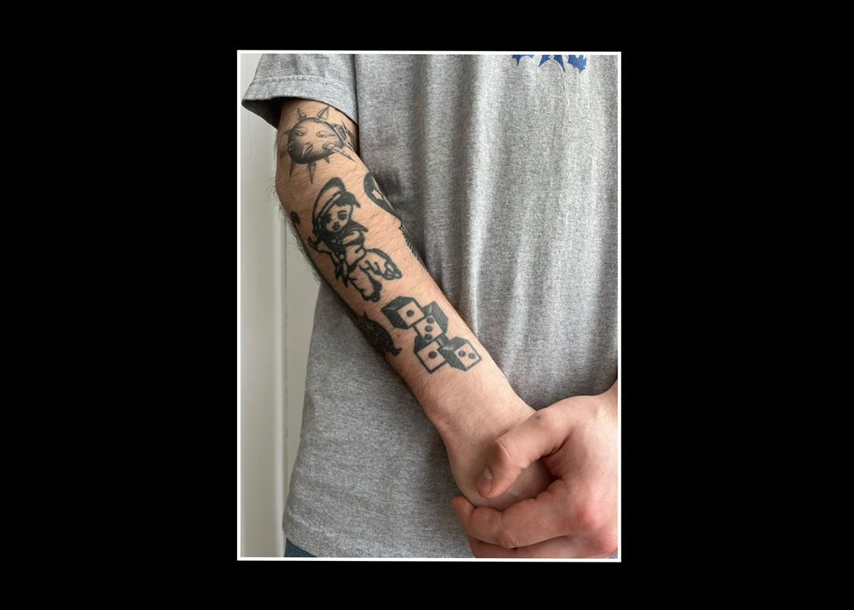 ACAB tattoos – four dice in black ink on someone's forearm with the numbers 1312