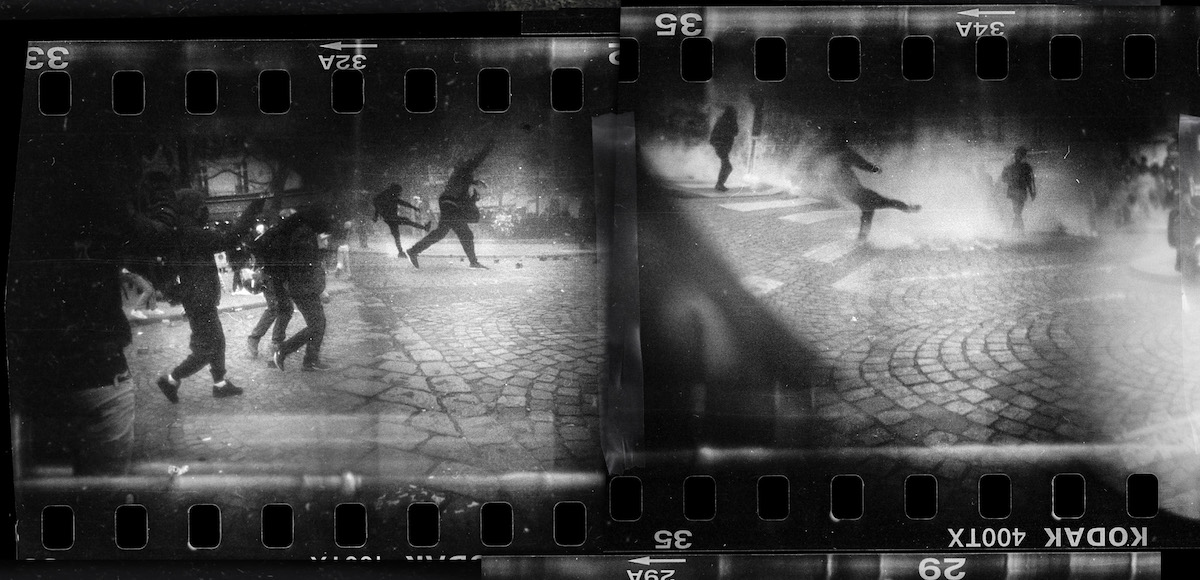 Steven Monteau photos with police weapons: black and white negative of a riot